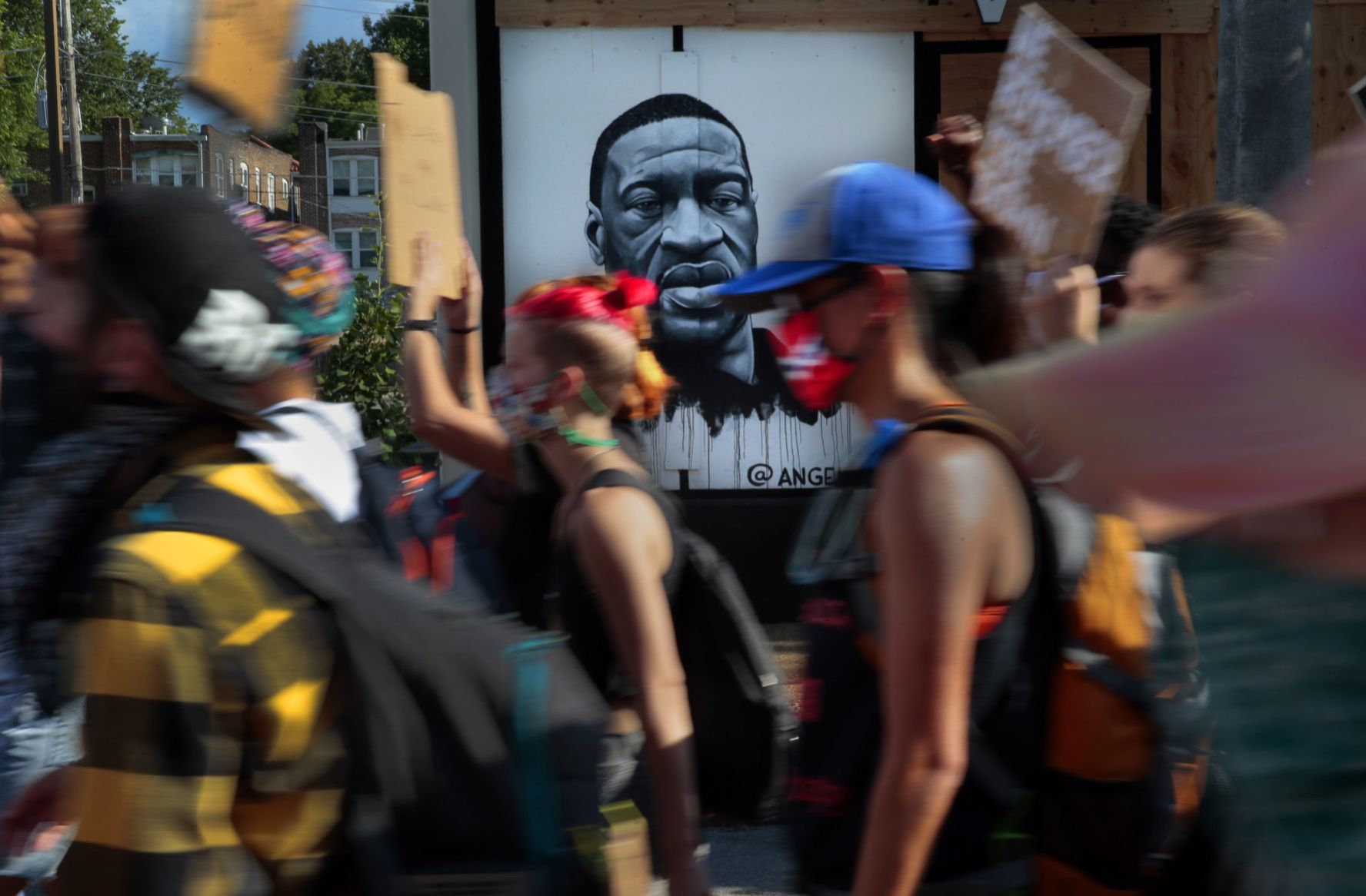 Protesters march through the Delmar Loop